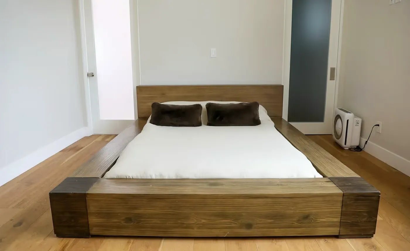 Minimalist wooden platform bed with white bedding