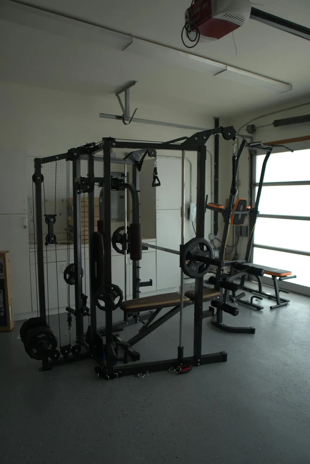 On-site gym with a cable weight machine, free weights and a bench