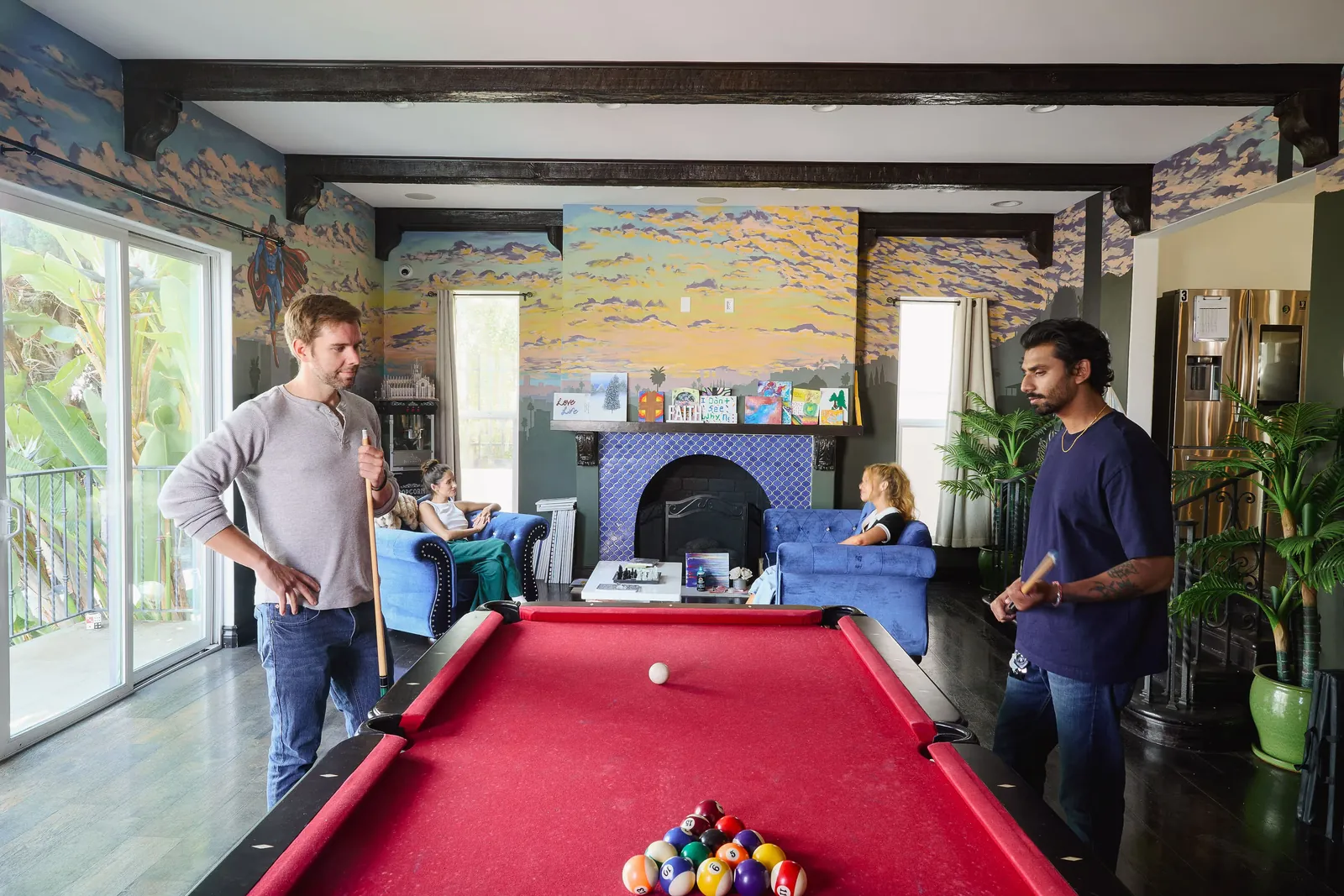 Residents playing pool in the mural room