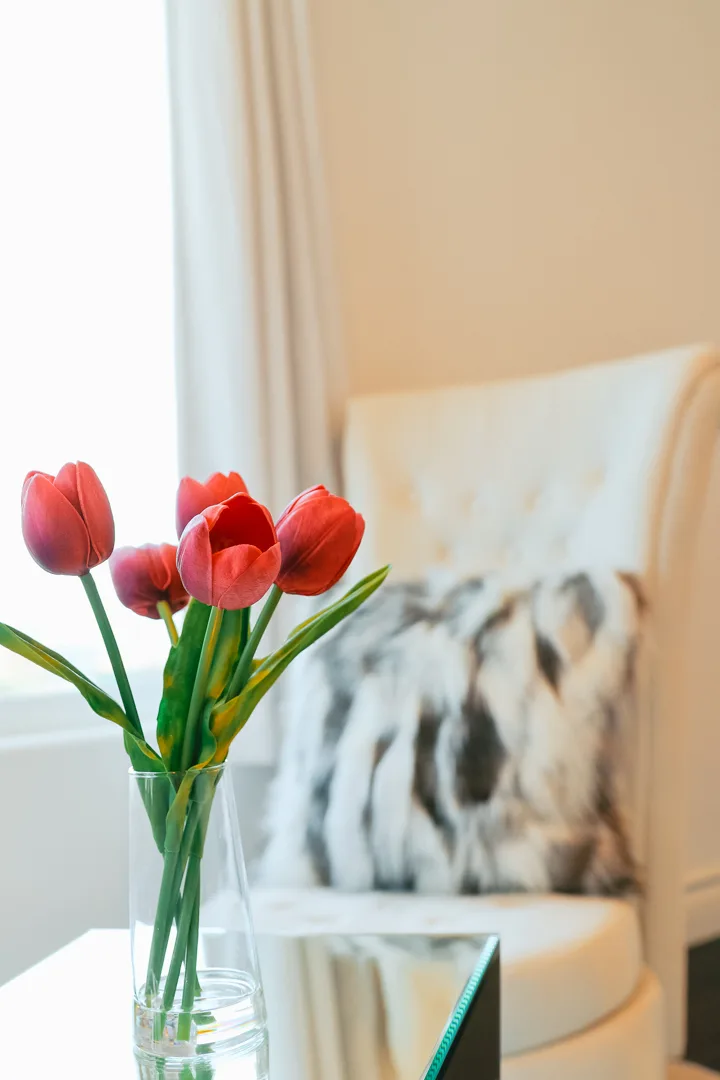 Fresh tulips beside a plush armchair inside the Hollywood Hills Recovery residence